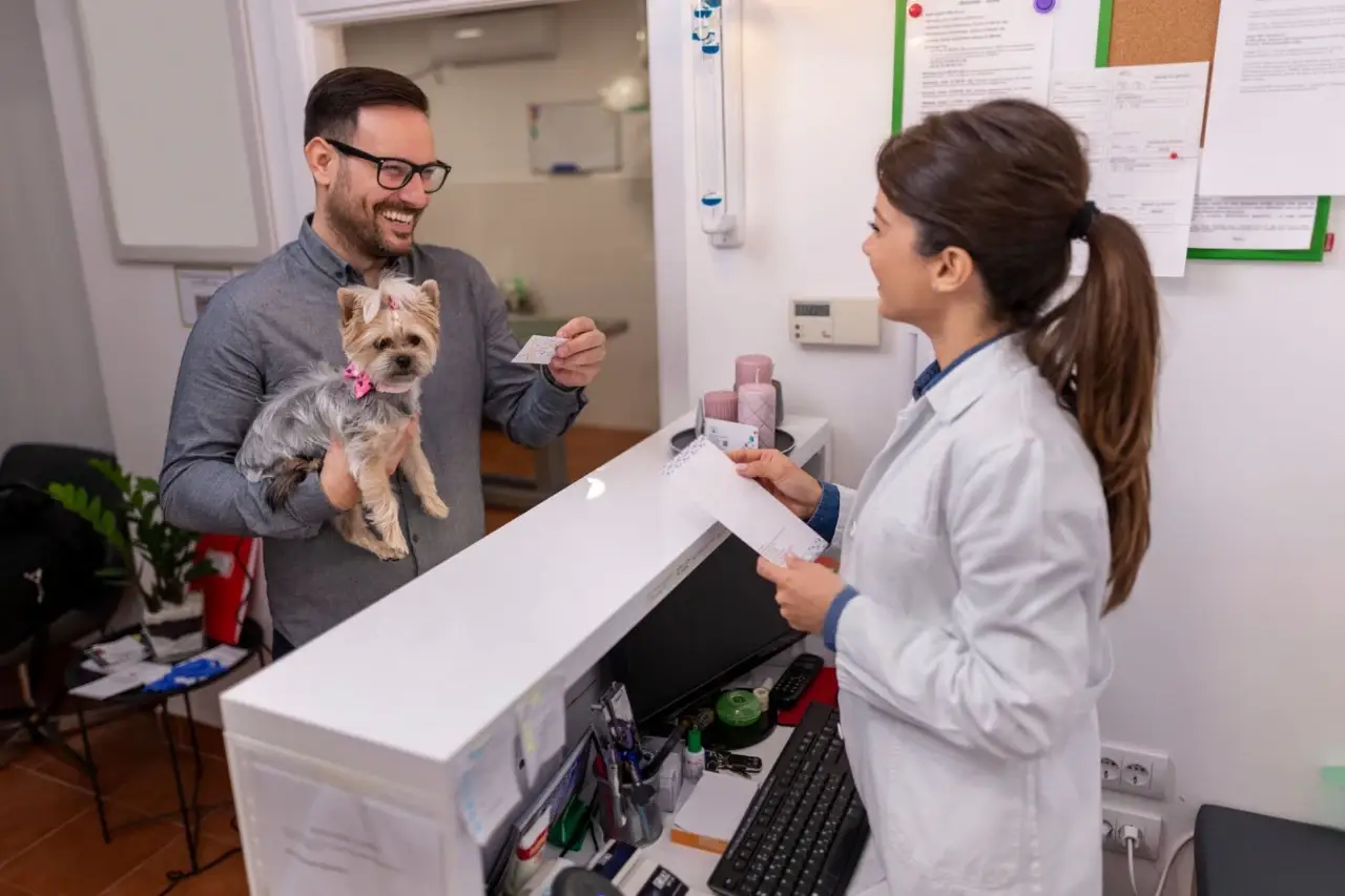 stock photo of a customer smiling while paying for something W